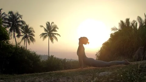 Young lady gets into downward facing dog asana slow motion Vidéo 112261753