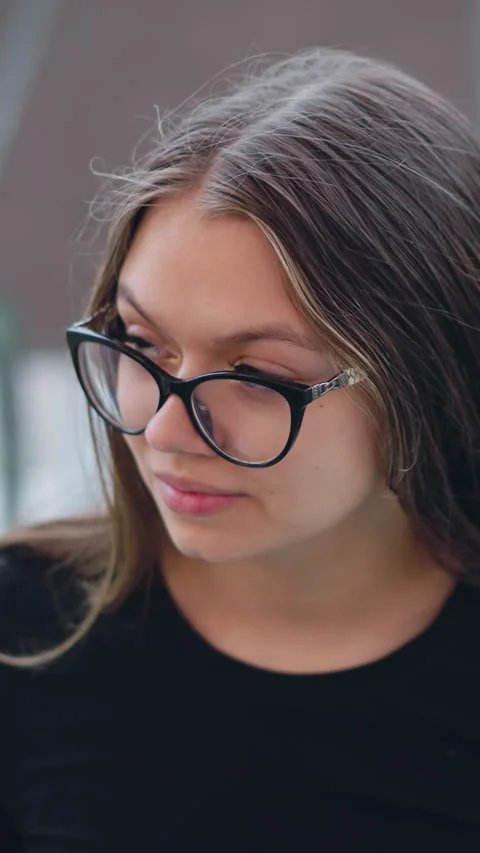 Young Lady in Glasses Glancing on Escalator with Blurred Background Stock Footage 318833405