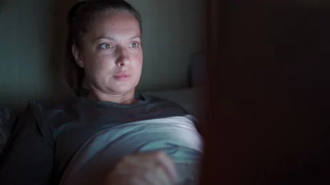 Young lady at home using laptop in bed watcing on computer screen female face Video stock 138523252