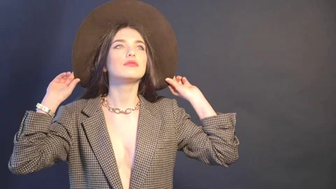 Young lady in jacket touches the hat and posing Stock Footage 73359242