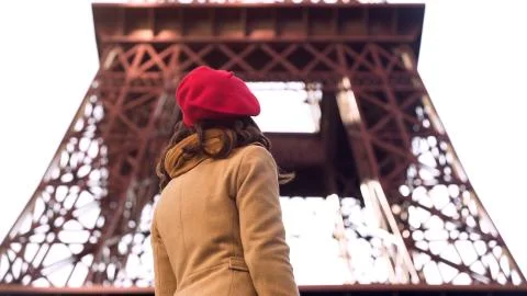Young lady looking at Eiffel Tower, sightseeing tour during vacation in Paris Stock Photos