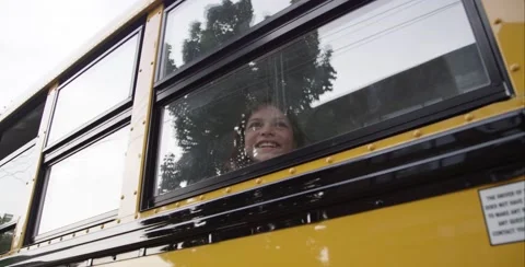 Young lady looking out the school bus window Stock Footage 53402505
