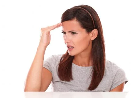 Young lady looking sick with headache on white background Stock Photos