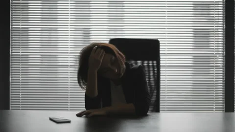 Young lady looking stressed out and exhausted, working overtime, expereincing Stock Footage 141650282