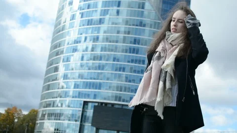 Young lady low angle portrait with modern building on the background 스톡 동영상 96114697