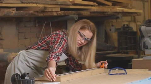 Young lady making marks on wooden piece Stock Footage 158237285