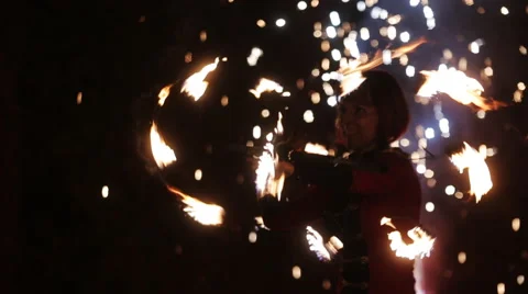 A young lady performing fire-show in the darkness Stock Footage 63865250