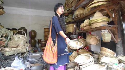 Young lady picking and choosing handmade bamboo weaving crafts in the store Stock Footage 41915935