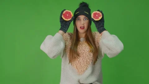 Young lady poses holding two slices of grapefruit with emotional eyes. Stock Footage 157937842
