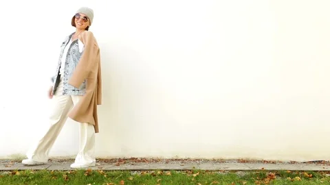 A young lady is posing on the background of white wall Stock-Footage 95679350