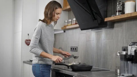 Young lady preparing food in kitchen Stock Footage 99077078
