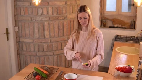 Young lady preparing food in a rustic kitchen. Stock Footage 266450976