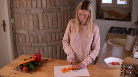 Young lady preparing food in a rustic kitchen. Video stock 266456153