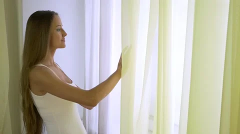 Young Lady Relaxing At The Window Stockbeeldmateriaal 59757651