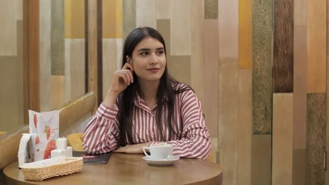 Young lady rests and drinks fresh coffee at round table Stock Footage 106327879