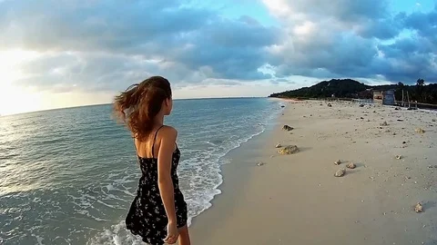 Young lady running on the beach at sunset Stock Footage 70814939