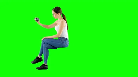 Young Lady Shakes an Empty Coffee Cup While Sitting Green Screen Stock Footage 137018732