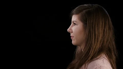 A Young Lady Shouting Against a Black Background Stock Footage 86620876