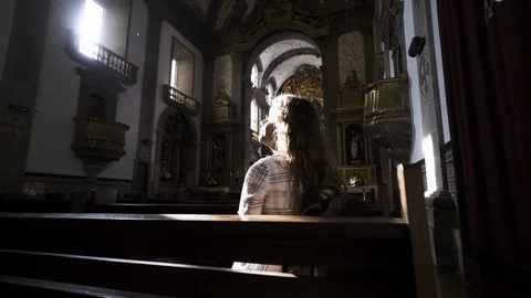 Young lady sitting on bench in cathedral Stock Footage 99478378