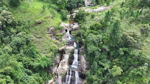 Young lady sitting in a natural pool of Diyaluma falls. Stock Footage 315337536