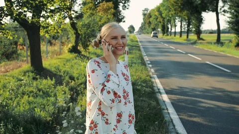 Young lady speaking on phone while hitchhiking. Stock Footage 97594516