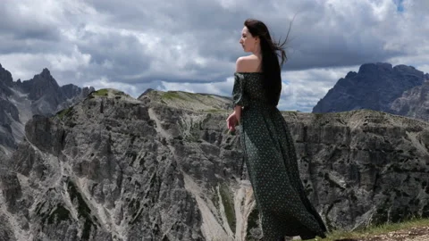 A young lady standing in front of a mountain peak Stock Footage 201489538