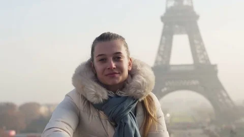 Young lady takes selfie in front of Eiffel tower in Paris Paris, France Stock Footage 74003131