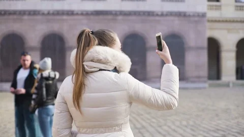 Young lady takes selfie in front of Eiffel tower in Paris Paris, France Stock Footage 74003149