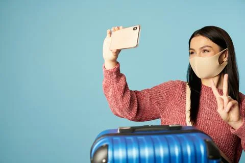 Young lady taking selfie while holding mobile phone Stock Photos