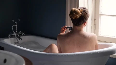 Young lady taking warm bath in apartment. Video stock 159338032