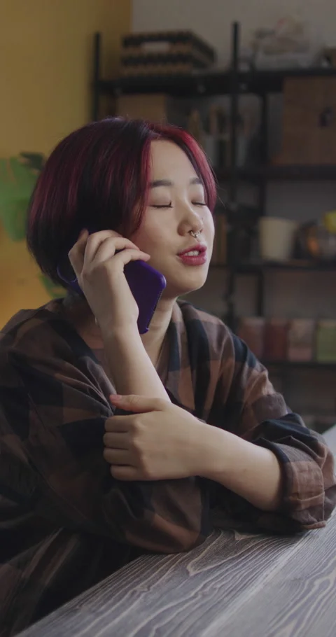 A young lady is talking on the phone Stock Footage 170464968