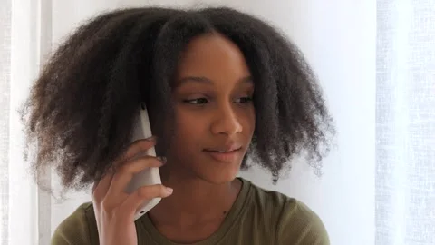 Young lady talking on smartphone with thoughtful expression. Communication Stock Footage 280437746
