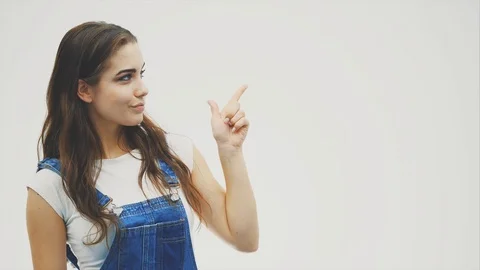 Young lady with thoughtful face expression is ponting at somerhing with her left Stock Footage 111848680