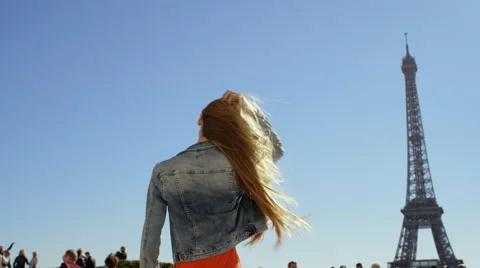 Young lady twirls with Eiffel tower in the bacground Stock Footage 63022089