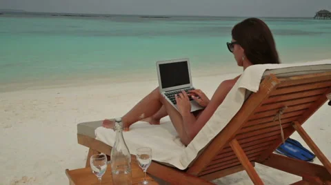 Young lady typing on laptop on vacation. Stock Footage 48856494