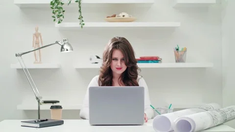 A Young Lady Using a Computer Indoors Stock Footage 83750026