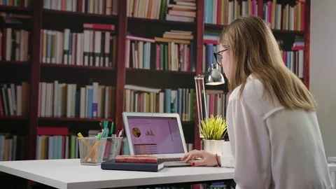 Young Lady Using a Laptop in the Library Stock Footage 85037345