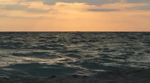 Young lady walking alone on the beach during sunrise Stock Footage 12274366