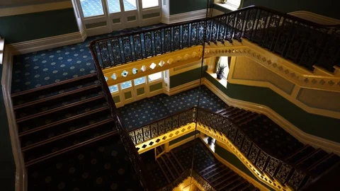 A young lady walking down the stairs at the Palace hotel in Buxton Stock Footage 104443766