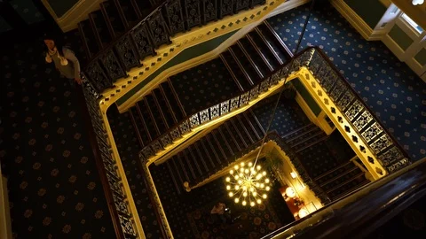 A young lady walking down the stairs at the Palace hotel in Buxton Stock Footage 104443813