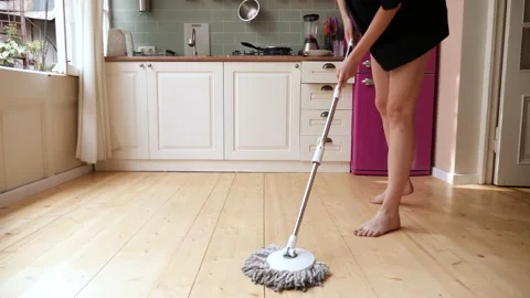 Young lady washes the floor in the kitchen. Stock Footage 159338751