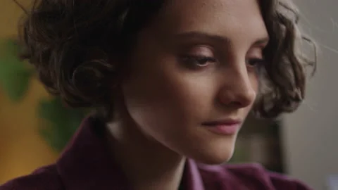 A young lady is watching something on the phone Stock Footage 170203084