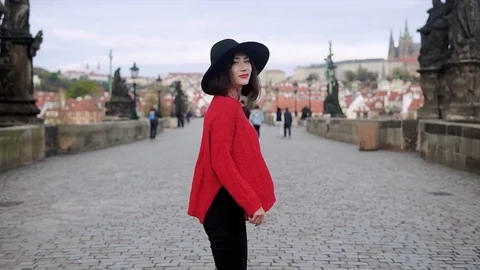 A young lady wearing hat walking in Prague Stock Footage 83746380