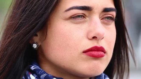 Young lady while looking on the mirror make her lips red lipstick on the street. Stock Footage 75582542