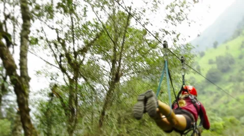 Young lady while zipline in the ecuadorian rainforest yelling and screaming Stock Footage