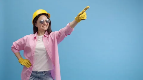 Young lady worker in yellow hard hat, american glasses and gloves Stock Footage 251002092
