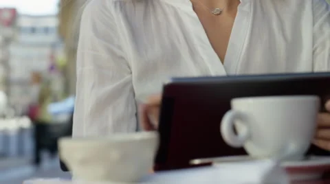 Young Lady working on her tablet while at a local cafe. Stock Footage 63020331