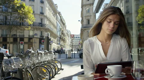 Young Lady working on her tablet while at a local cafe. Video stock 63022287