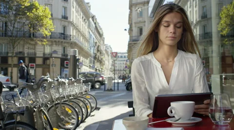 Young Lady working on her tablet while at a local cafe. Video stock 63023967