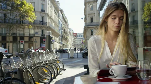 Young Lady working on her tablet while at a local cafe. Stock Footage 63032079
